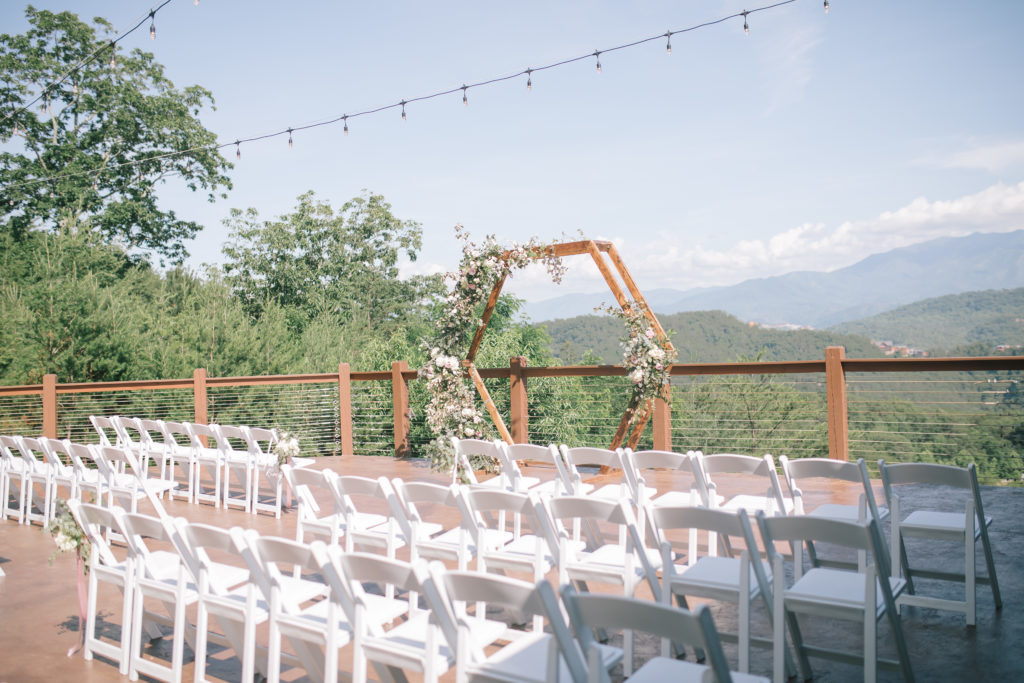 Pigeon Forge wedding venue outdoor ceremony space with white outdoor chairs and stunning views of the Smokies