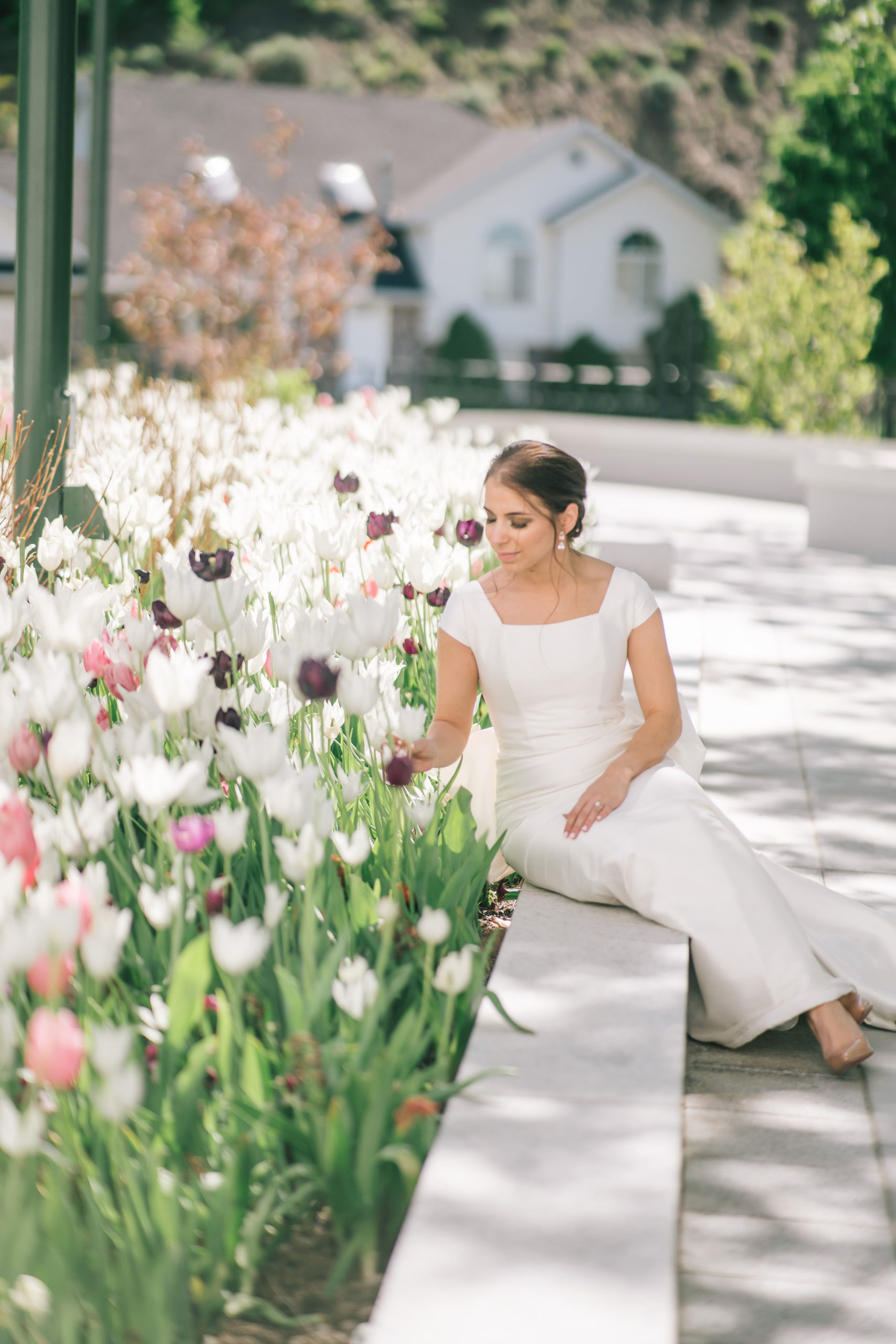 Amalfi Coast Themed Wedding Italian bride sitting ina garden outside of an lds temple lookign at a tulip garden in the Spring