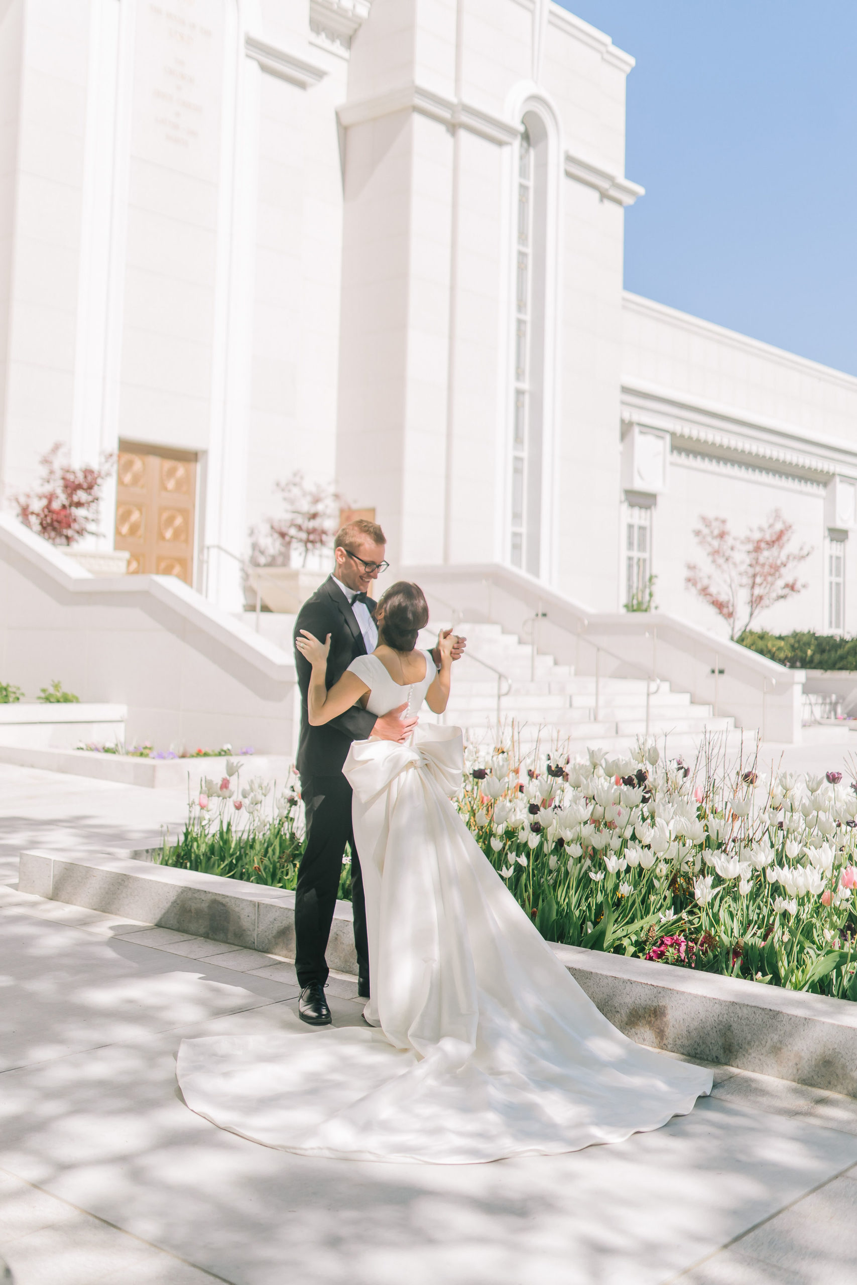 Amalfi Coast Themed Wedding bride and groom romatnically slow dancing in front of an lds temple in Utah for their wedding day