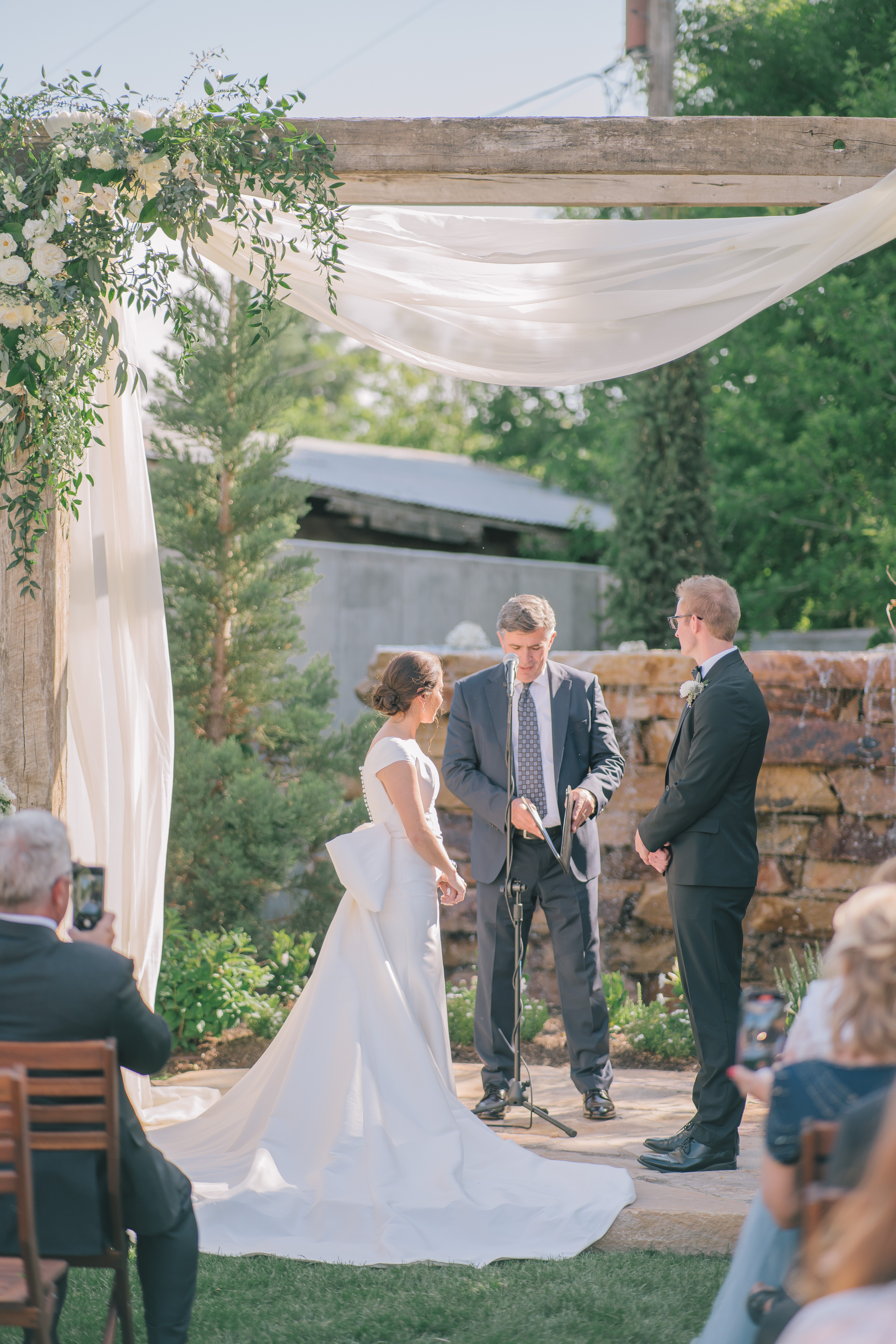 bride and groom read their vows to one another during their Italian backyard wedding in Utah