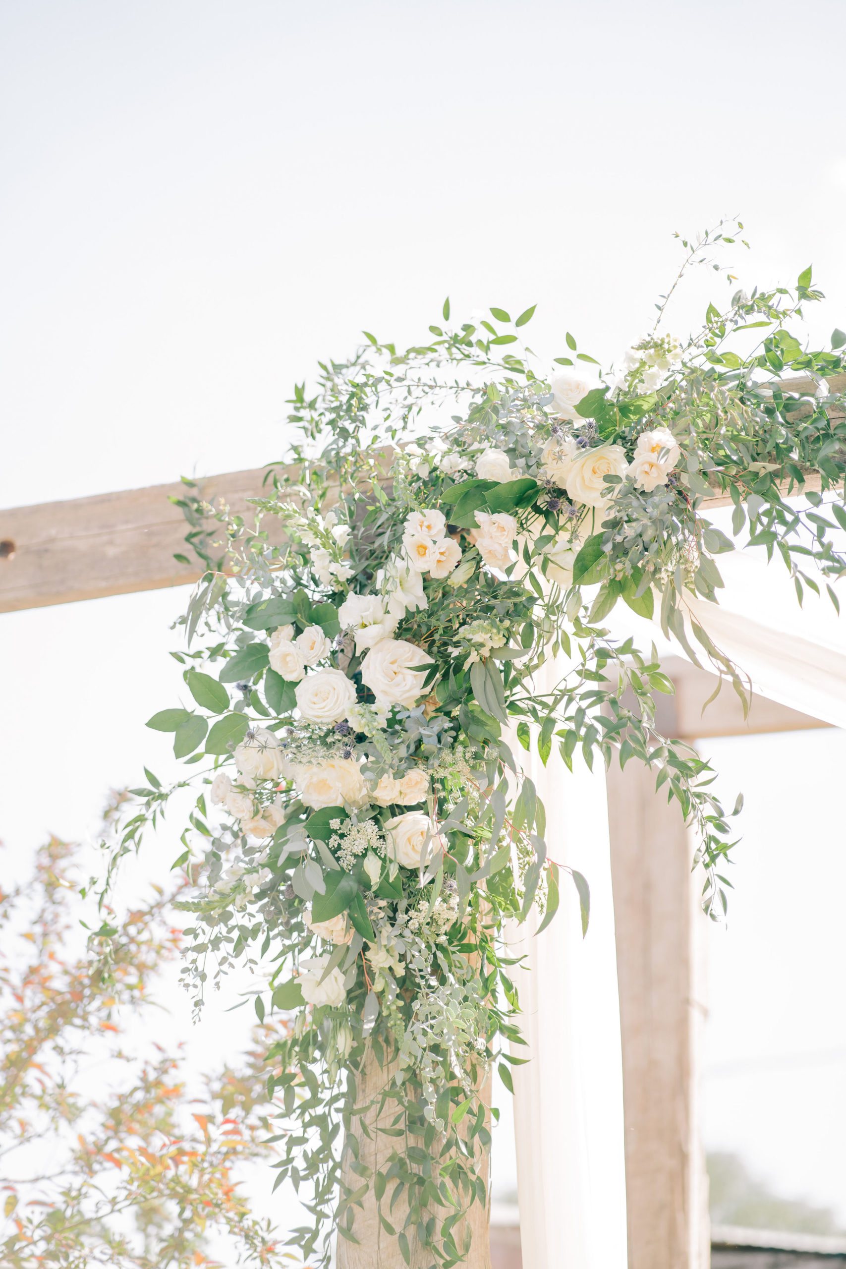 stunning florals for an Italian wedding on top of a wedding ceremony arch