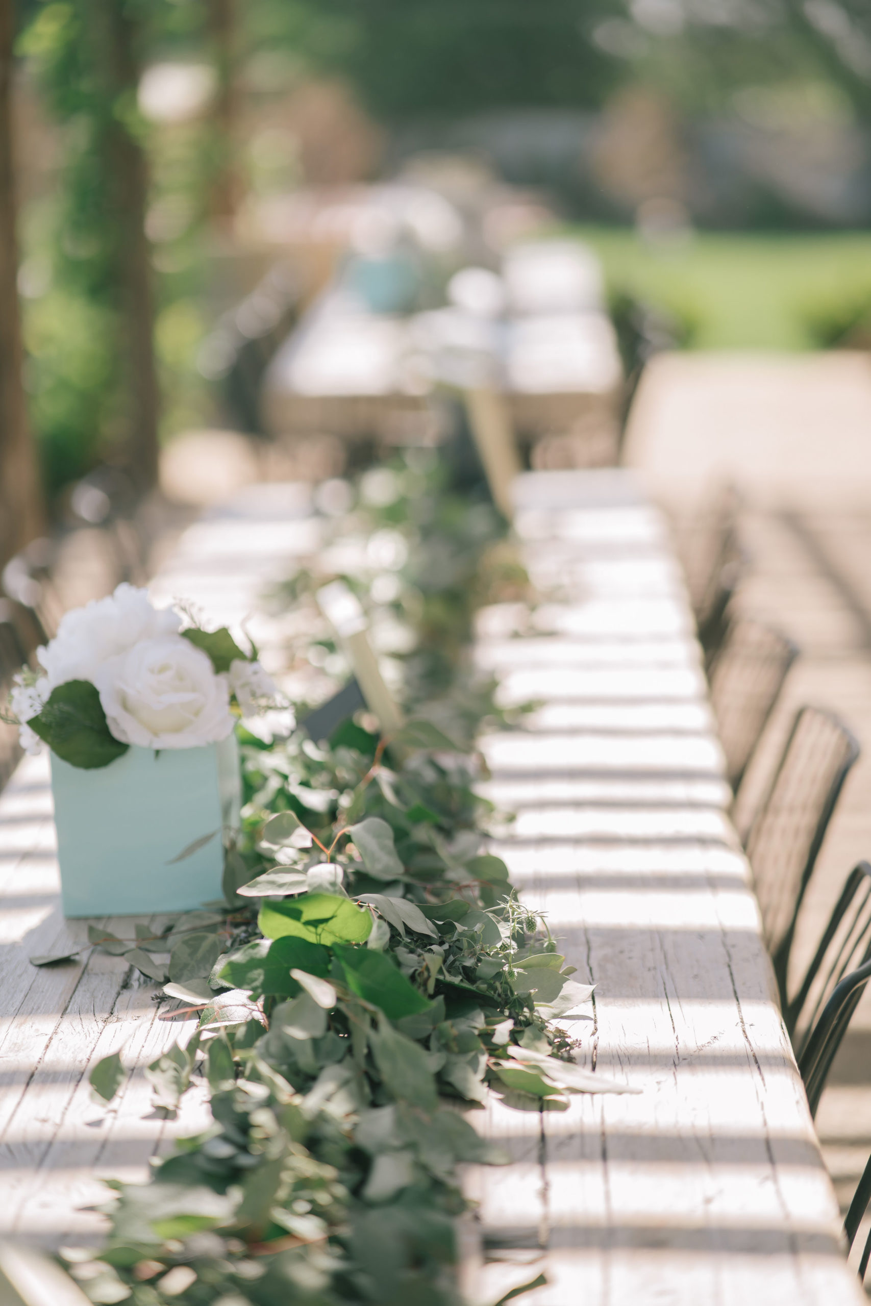 stunning out door table set up for a wedding day in ITaly with greenery and white florals